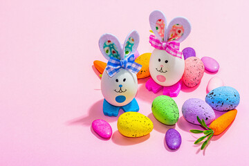 Festive Easter composition. Traditional symbols and decor - rabbits, eggs, carrots. Pastel design