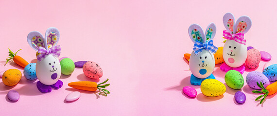 Festive Easter composition. Traditional symbols and decor - rabbits, eggs, carrots. Pastel design