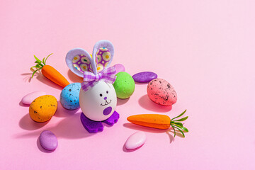 Festive Easter composition. Traditional symbols and decor - rabbits, eggs, carrots. Pastel design