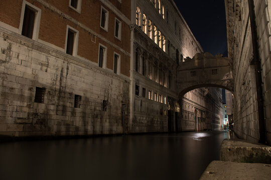 Long exposure night photography of the canal under the Bridge of Sighs in the city of Venice