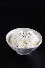 Japanese rice on cup isolated in black background