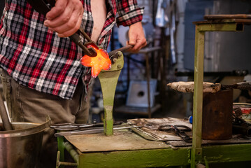 A glassworks worker shows traditional methods of making decorative glass.
