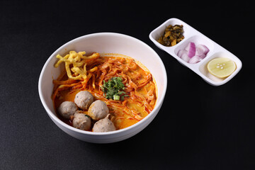 Khao Soi Thai Curry soup isolated in black background
