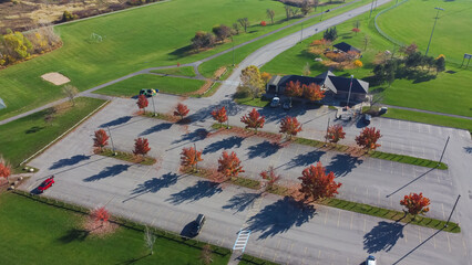 Huge grassy soccer fields near empty parking lots colorful fall foliage at community recreational...