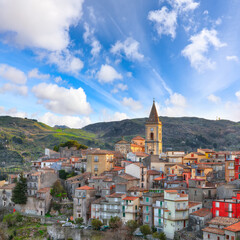 Fototapeta na wymiar Amazing Panorama of the belltower and the village in the valley at early sunrise.