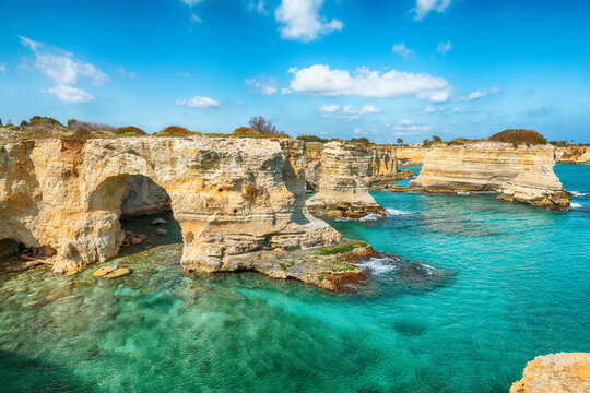 Stunning seascape with cliffs rocky arch and stacks (faraglioni) at Torre Sant Andrea