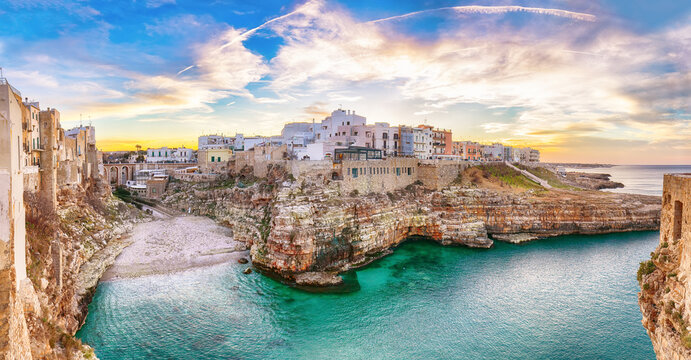Stunning sunset at Cala Paura gulf with Bastione di Santo Stefano and Lama Monachile beach in background.