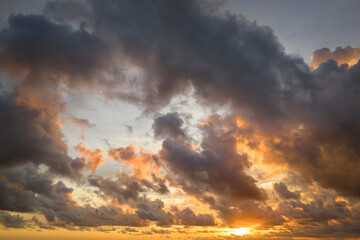 Fototapeta premium White fluffy cumulonimbus clouds forming before thunderstorm on evening sky. Changing stormy cloudscape weather at sunset
