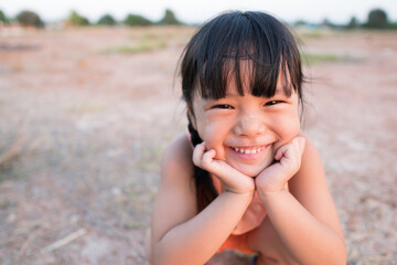 Asian child poor happiness or kid girl smile with laugh and happy fun because come back home to...