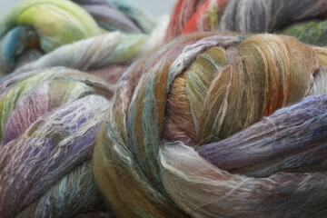 Fototapeta premium Closeup of lots of beautiful merino wheep wool fibres in a roving ready for spinning yarn on a spinning wheel as a hobby
