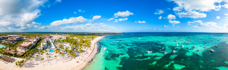 Aerial panorama of the large tropical beach with white sand and turquoise water of the Caribbean Sea. Best All Inclusive Hotels in Punta Cana