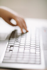 Close-up of male hands typing on laptop keyboard indoors. Businessman working in office or student browsing information. input data for information analysis and sending an email message
