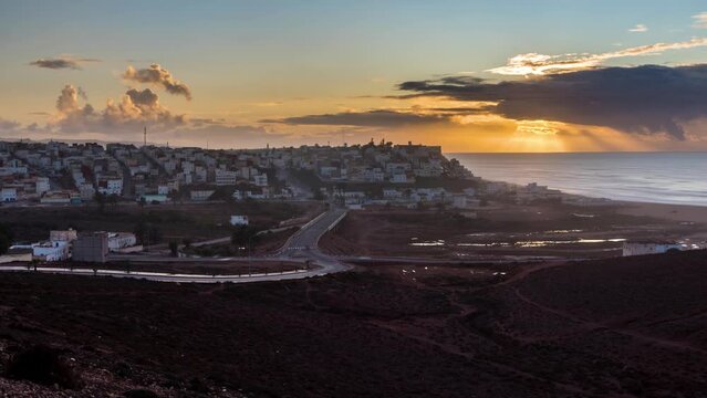 Sunset evening sky over Sidi Ifni town in Morocco ocean coast Time lapse landscape