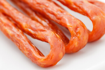 Pork or beef sausage, kabanos sausages, meat stick smoked close-up, selective focus