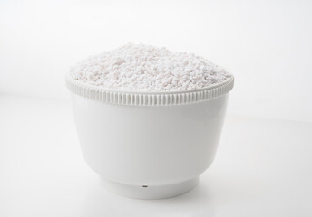 Perlite for plants in a bowl on a white background. 