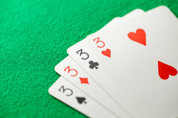 Playing cards, poker combination four of kind, quads, threes of different suits, same value