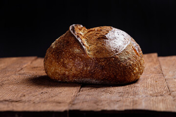 Rustic sourdough bread on rustic wooden background. Foreground