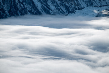 Panorama on Mont Blanc. Mountain wrapped in snow and white clouds.