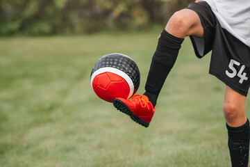 Football practice and football game. Close-up of a soccer player's leg in football boots and spats....