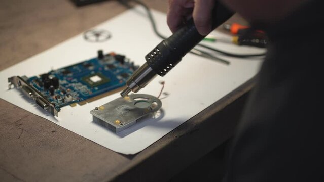 a man makes repairs and cleaning of a pc video card. High-quality shooting in 4k format