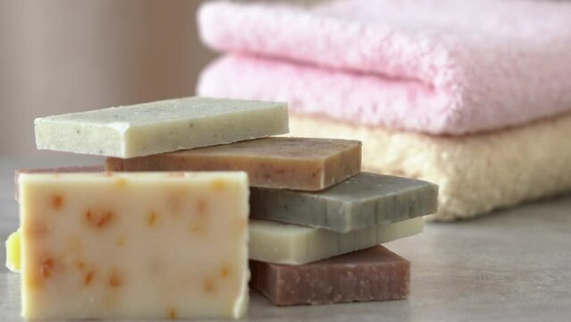 Camera movement on soap on background of cotton terry towels. Spa, bath, bathroom. Skin body care