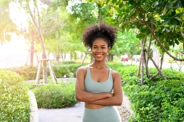 Portrait of black woman, afro hairstyle in outdoor park. Beautiful African woman preparing,...