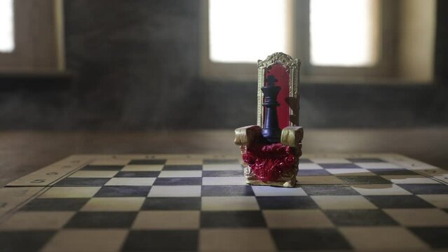 Red royal chair (Medieval Throne) miniature on chessboard. . Chess board game concept of business ideas and competition and strategy ideas concept. Selective focus