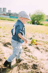 little boy in the blue shirt and brown cap portrait