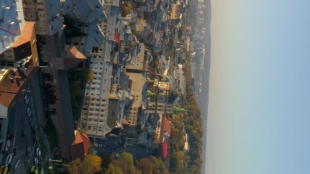 Vertical video. Flight over the Ukrainian city of Lviv. The old part of the city in the evening sunset. Drone view.