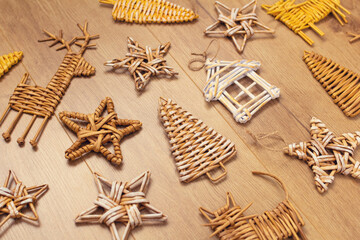wicker Christmas decoration for Christmas tree or home on a wooden background