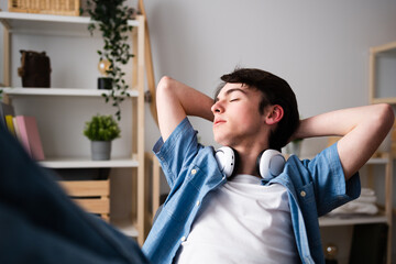 Fototapeta premium Teenager boy relaxing feet on desk