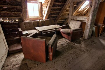 Abandoned place Residential house: attic room with bright, antique window and familiar armchairs...