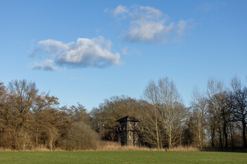 Fototapeta premium Historic watch tower remains of roman regiment fortification part of the original Waterlinie defense settlement. Archaeological site in Dutch landscape.