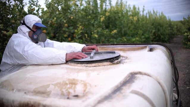 Tractor spraying pesticide drone aerial view, pesticides or insecticide spray on lettuce or iceberg field. Pesticides and insecticides on agricultural field in Spain