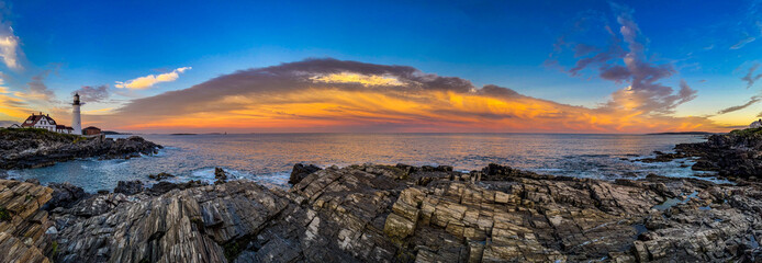 Panoramic view of a lighthouse and the coast at sunset