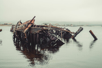 The skeleton of an old ship on the embankment