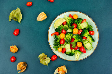 Spring vegetable salad decorated with physalis.