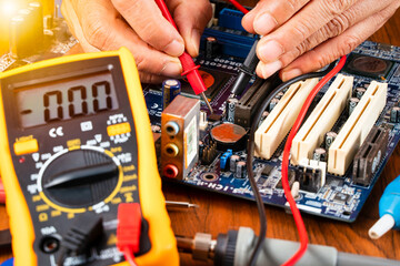 Man fixing malfunction mainboard. Man repairing mainboard.