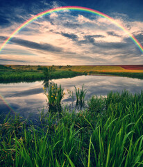 Landscape with a Rainbow on the River in Spring. colorful morning. nature of Ukraine