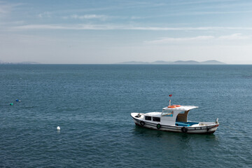 A small boat is anchored in the sea.