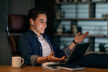 Happy young man entrepreneur have video call with business partners