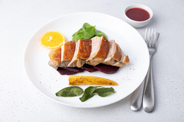 Files of the breast duck grill with beets, mini corn and spinach, fried sage, orange and lingonberry sauce. Traditional Mediterranean cuisine. Selective focus, close-up.