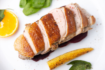 Files of the breast duck grill with beets, mini corn and spinach, fried sage, orange and lingonberry sauce. Traditional Mediterranean cuisine. Selective focus, close-up.