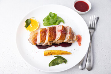 Files of the breast duck grill with beets, mini corn and spinach, fried sage, orange and lingonberry sauce. Traditional Mediterranean cuisine. Selective focus, close-up.