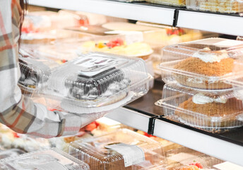 The girl takes the cake from the counter.