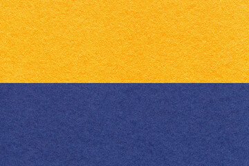 Texture of craft yellow and navy blue paper background, macro. Vintage golden and denim cardboard.