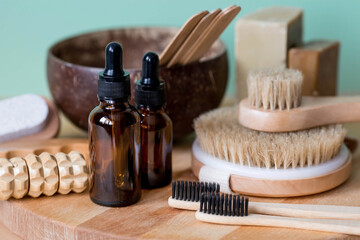 Aromatherapy. A glass bottle with a pipette for oil, lotion, cream, massage brushes and bath accessories. Natural organic eco-cosmetics. The layout of the corporate identity of the beauty salon.