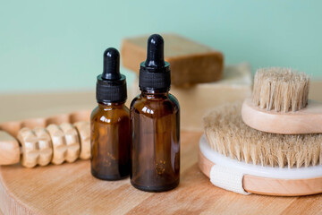 Aromatherapy. A glass bottle with a pipette for oil, lotion, cream, massage brushes and bath accessories. Natural organic eco-cosmetics. The layout of the corporate identity of the beauty salon.