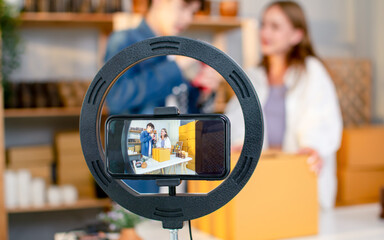 Selective focus mobile phone recording live streaming in online social media selling products by...