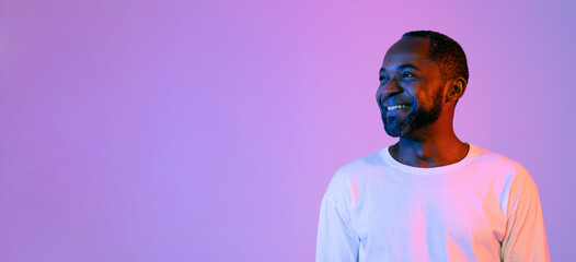 Cheerful handsome african american man looking at copy space